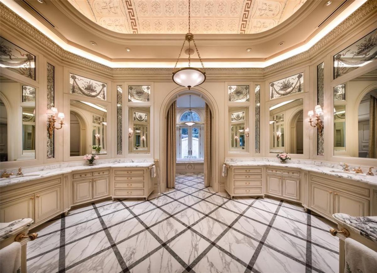 Bathroom sinks, mirrors and a marble counter top.