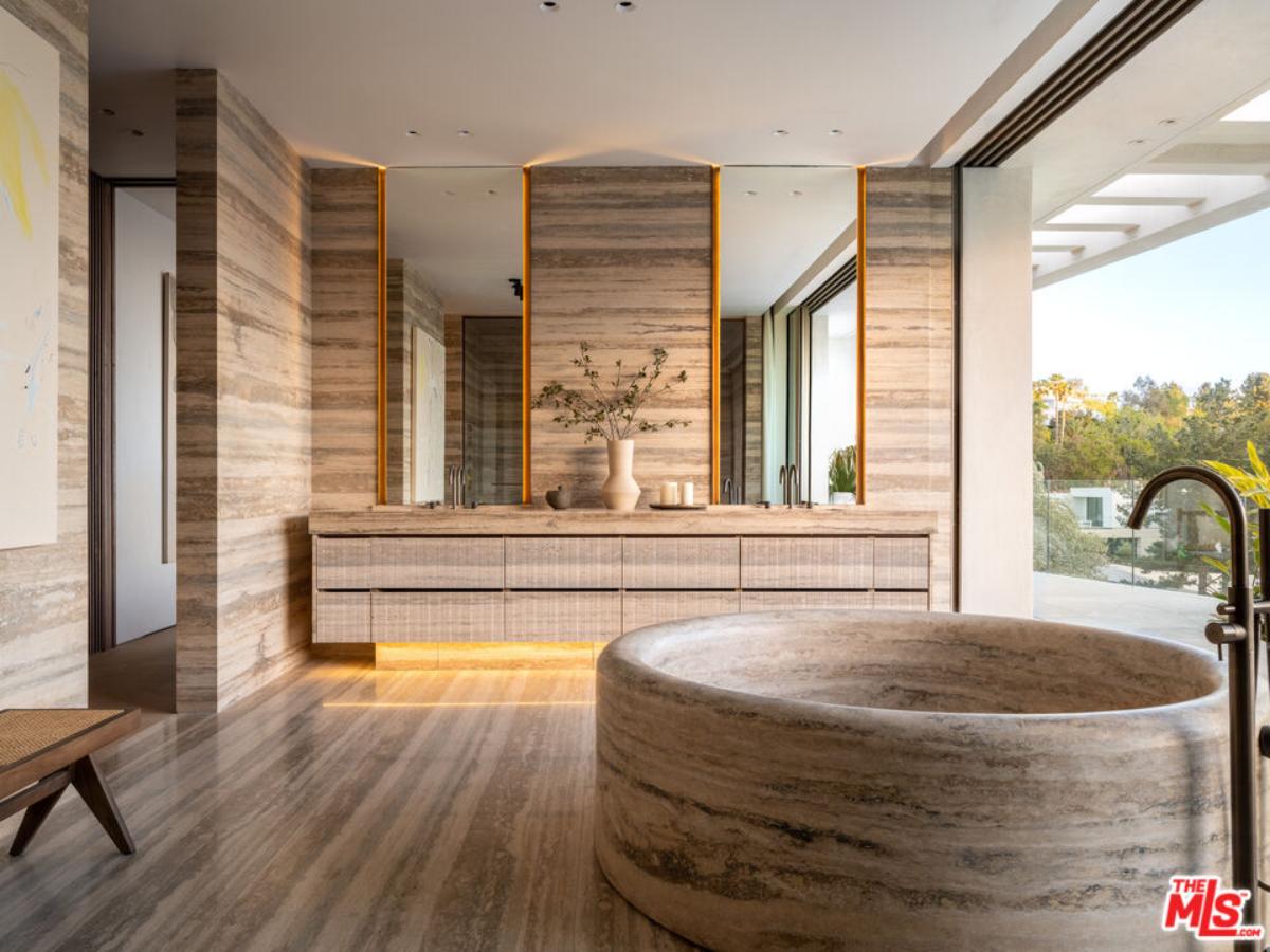 Bathroom with a soaking tub and sinks.