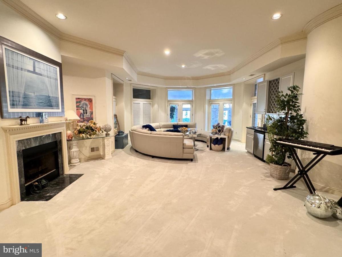 Living room with a fireplace, tables and chairs.