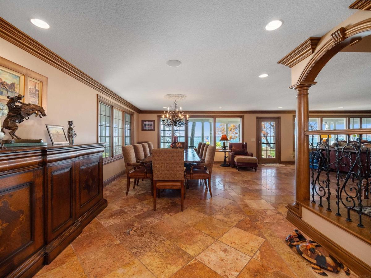 Dining room with a large table, chairs, and a chandelier.