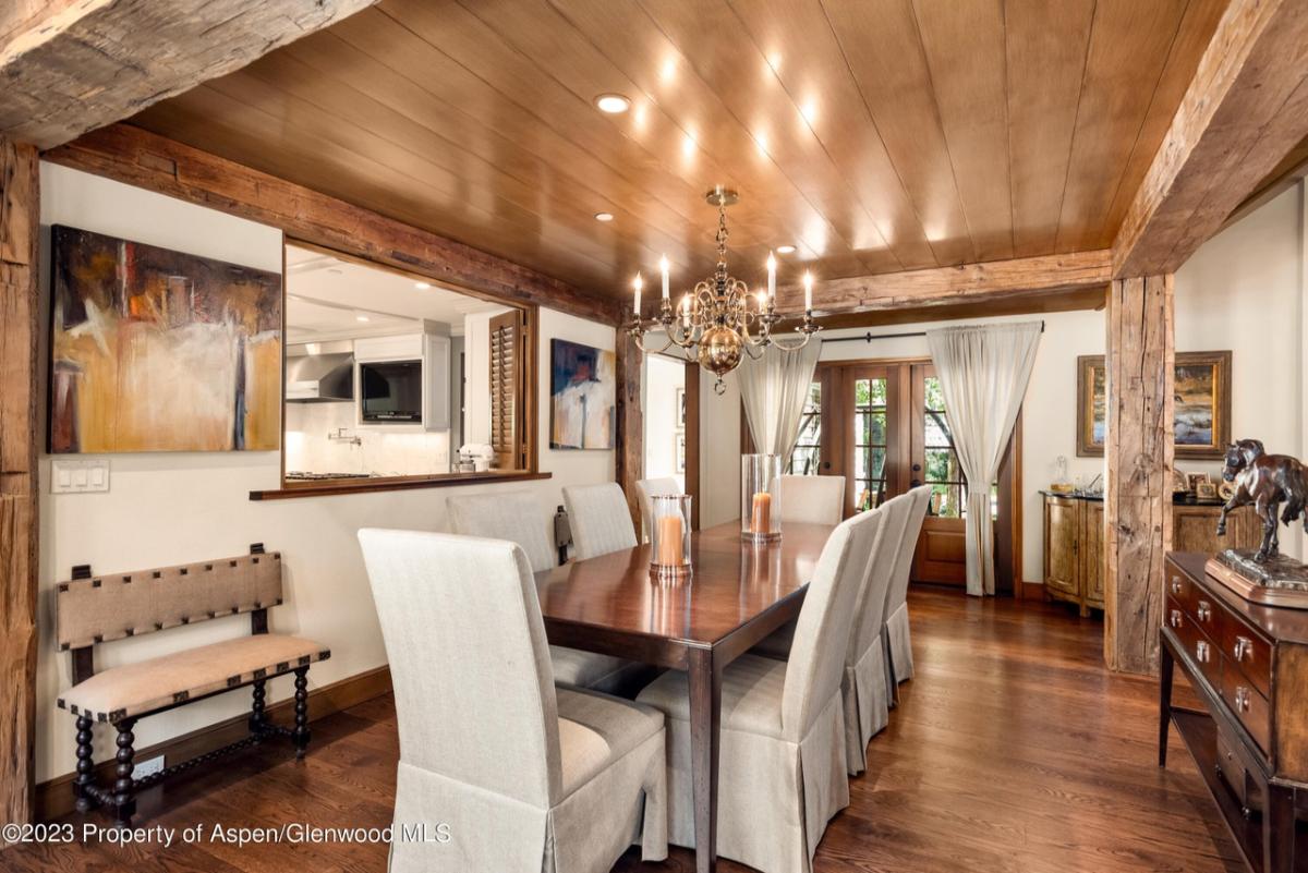 Dining room with a wooden table, chairs and a wood flooring.