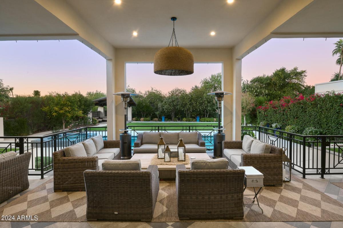 Covered patio with couches and custom lights.