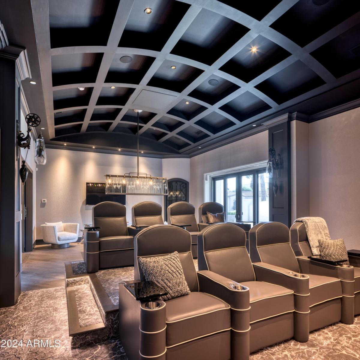 Home theater with chairs and custom lights.