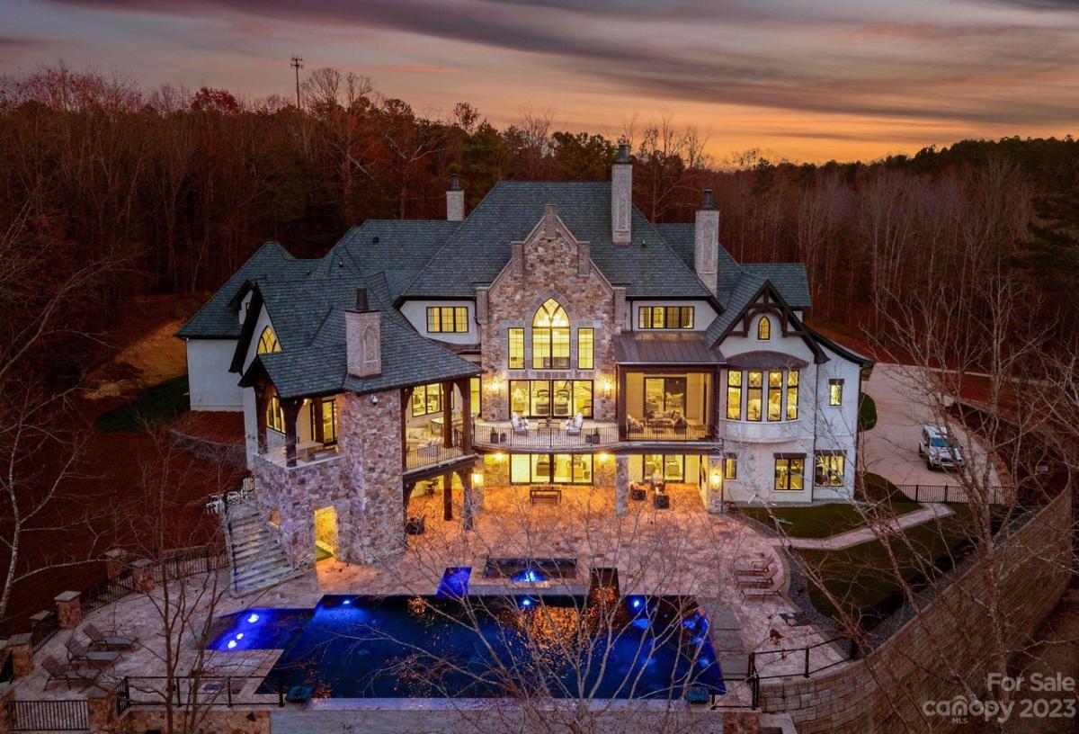 Aerial rear view of the mansion with a pool.