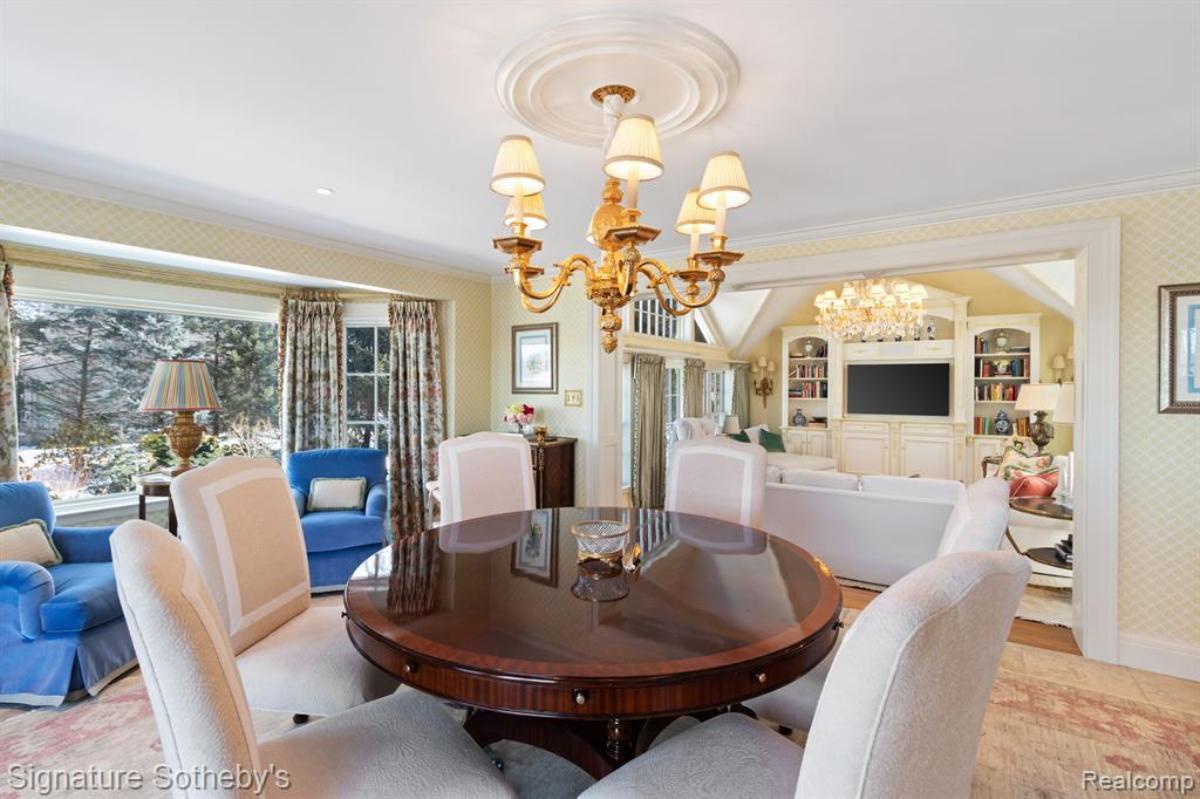 Great room with chandeliers and glass walls.