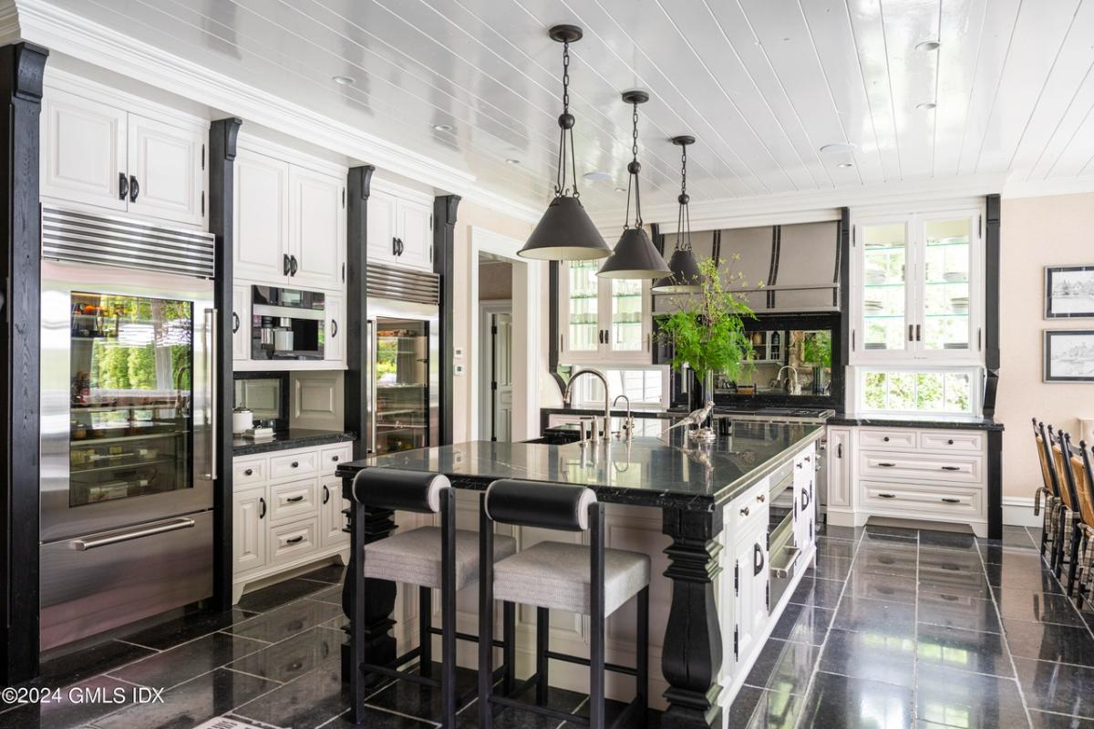 Kitchen with a large island, stainless-steel appliances and custom cabinetry.