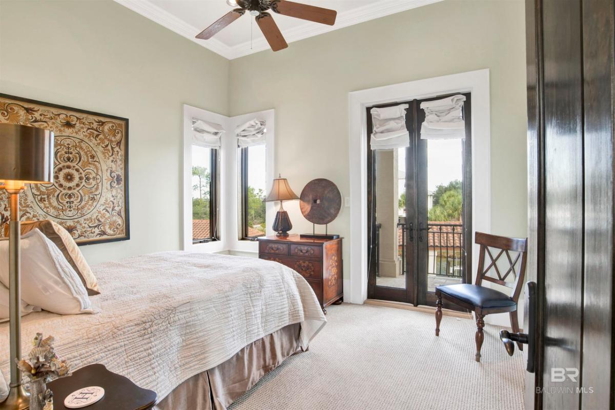 Bedroom with carpet flooring, glass windows and glass doors.