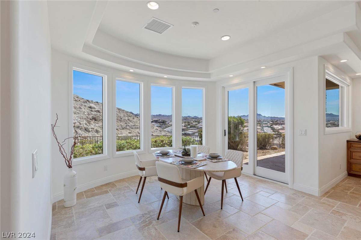 Breakfast nook with sliding glass door and glass windows.