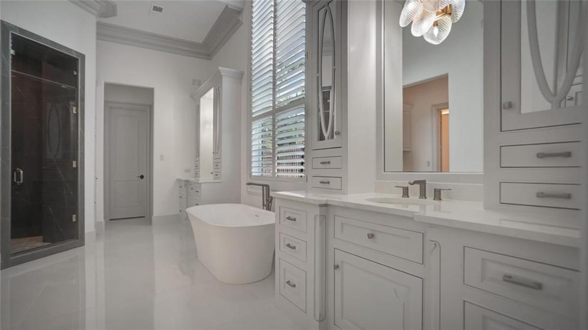 Bathroom with dual sink, walk-in shower and a soaking tub.