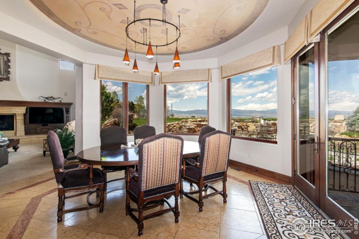 Dining room with a large wood table and chairs.