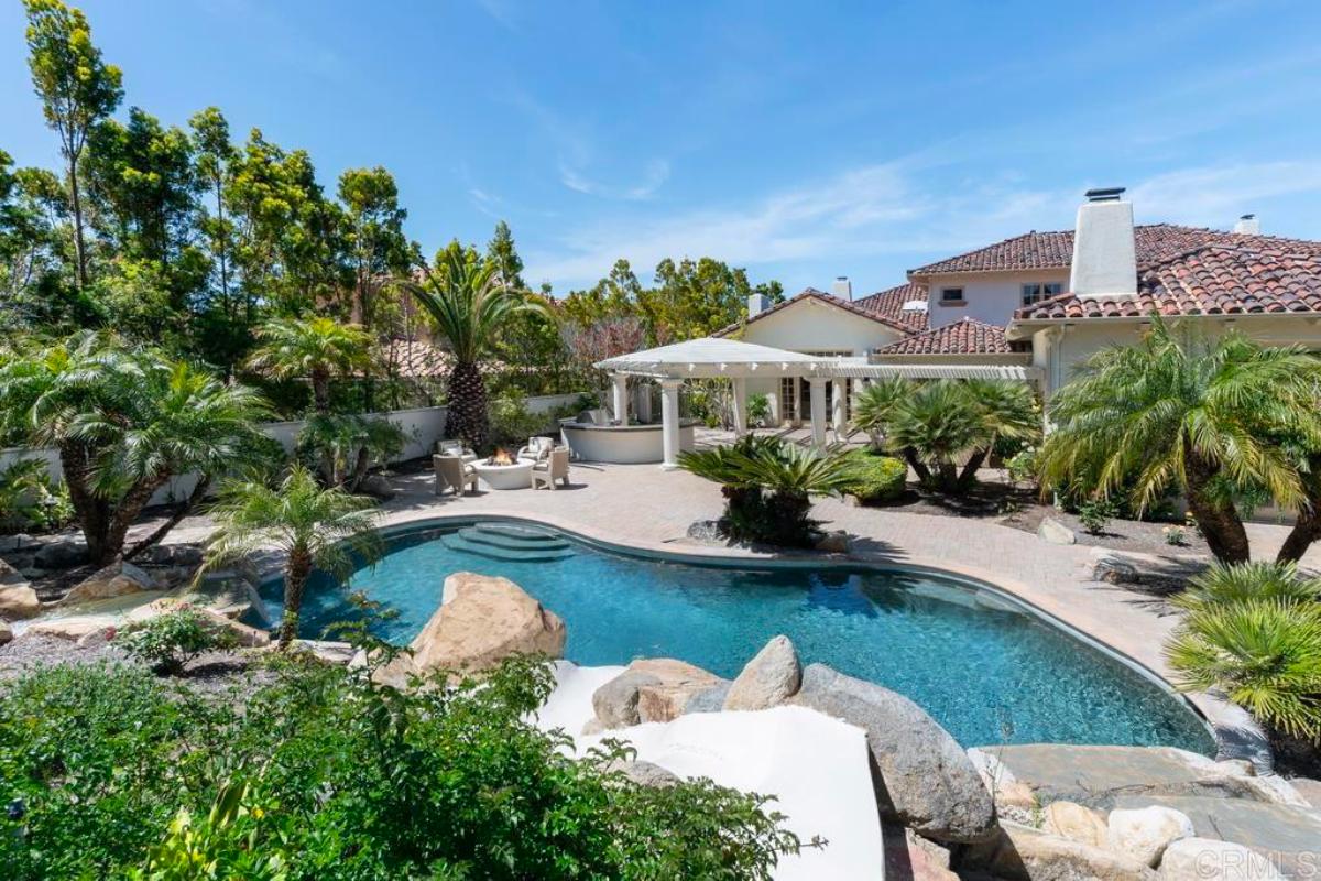 Rear view of the mansion with a pool.