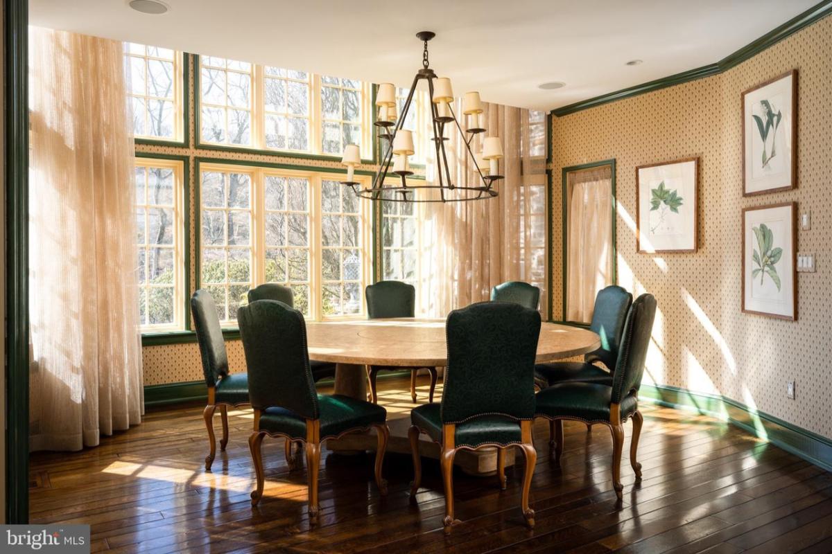 Dining room with a chandelier and wood flooring.
