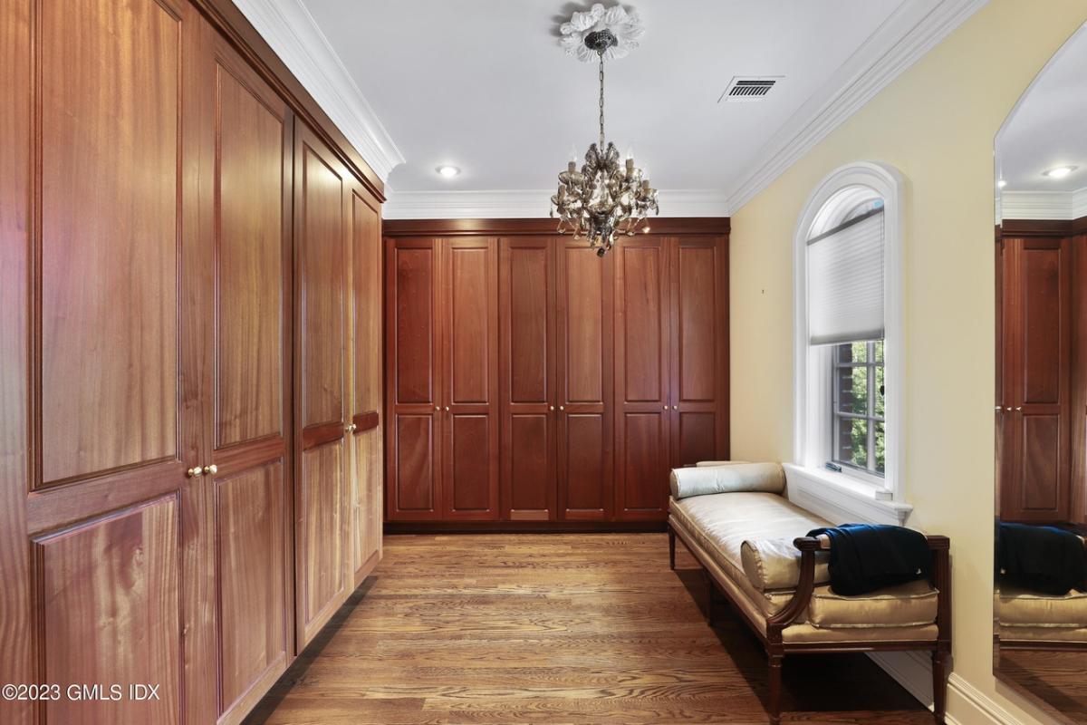 Walk-in closet with a chandelier.