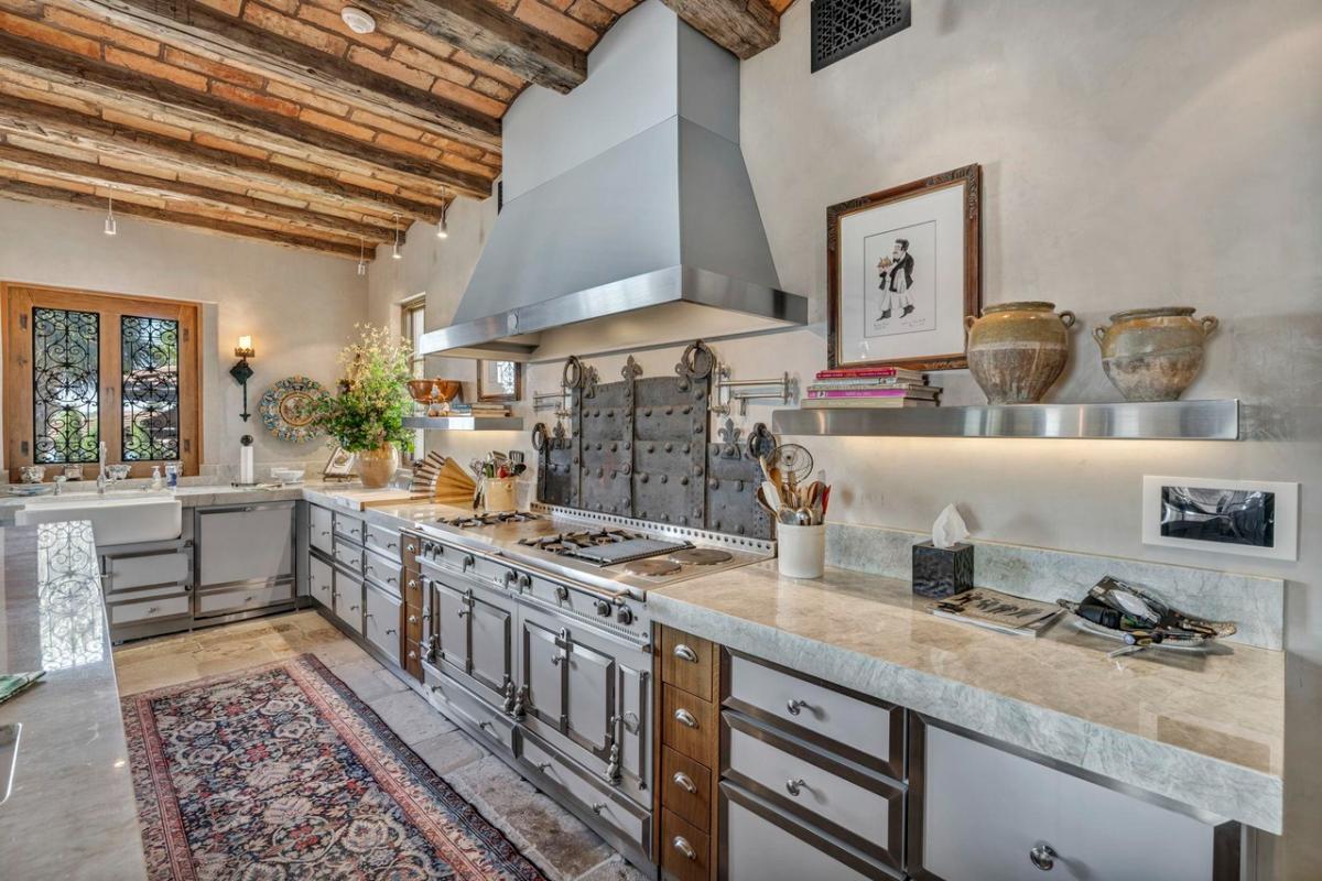 Kitchen with wood ceiling beams and custom cabinetry.