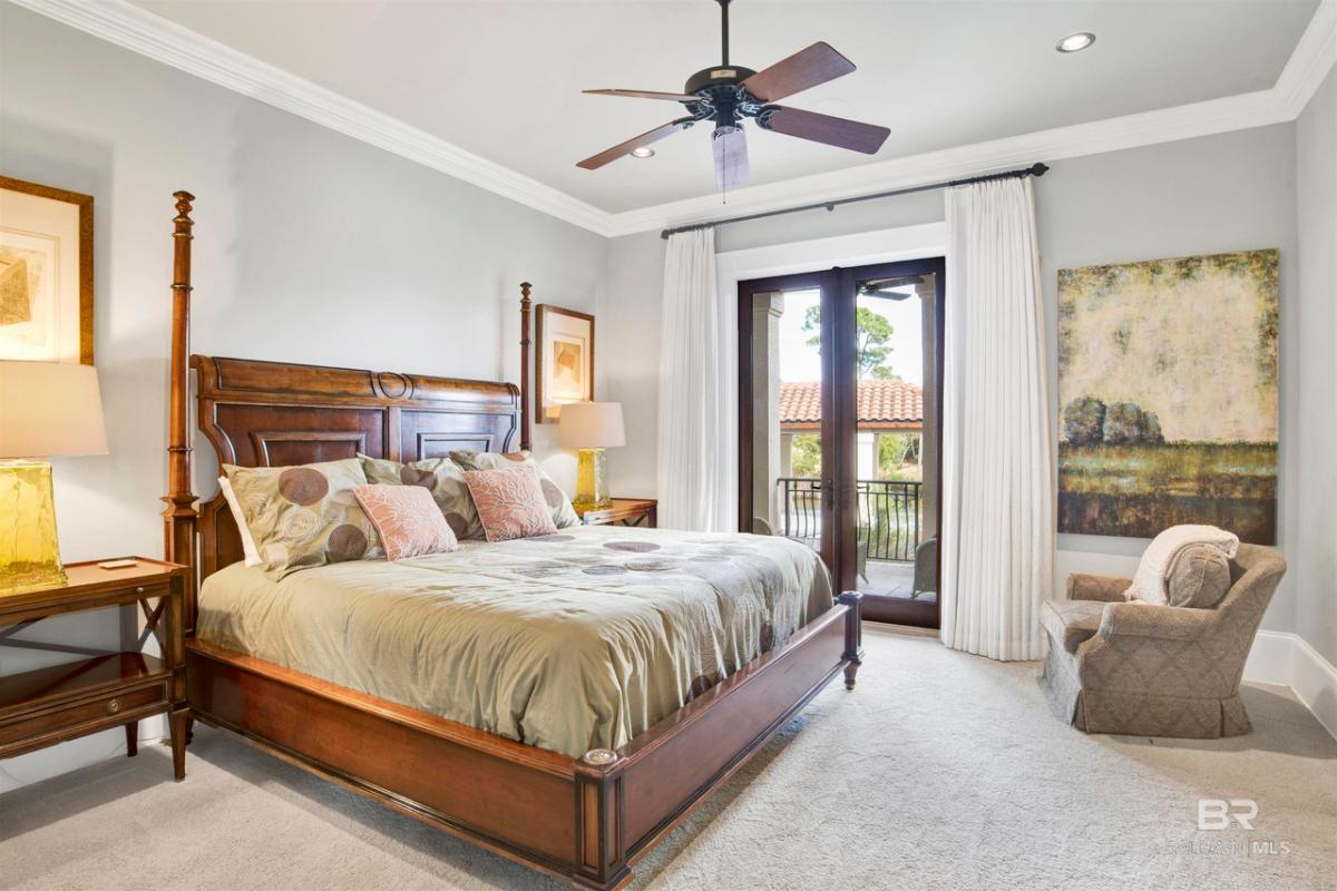 Bedroom with carpet flooring, couch and glass doors.