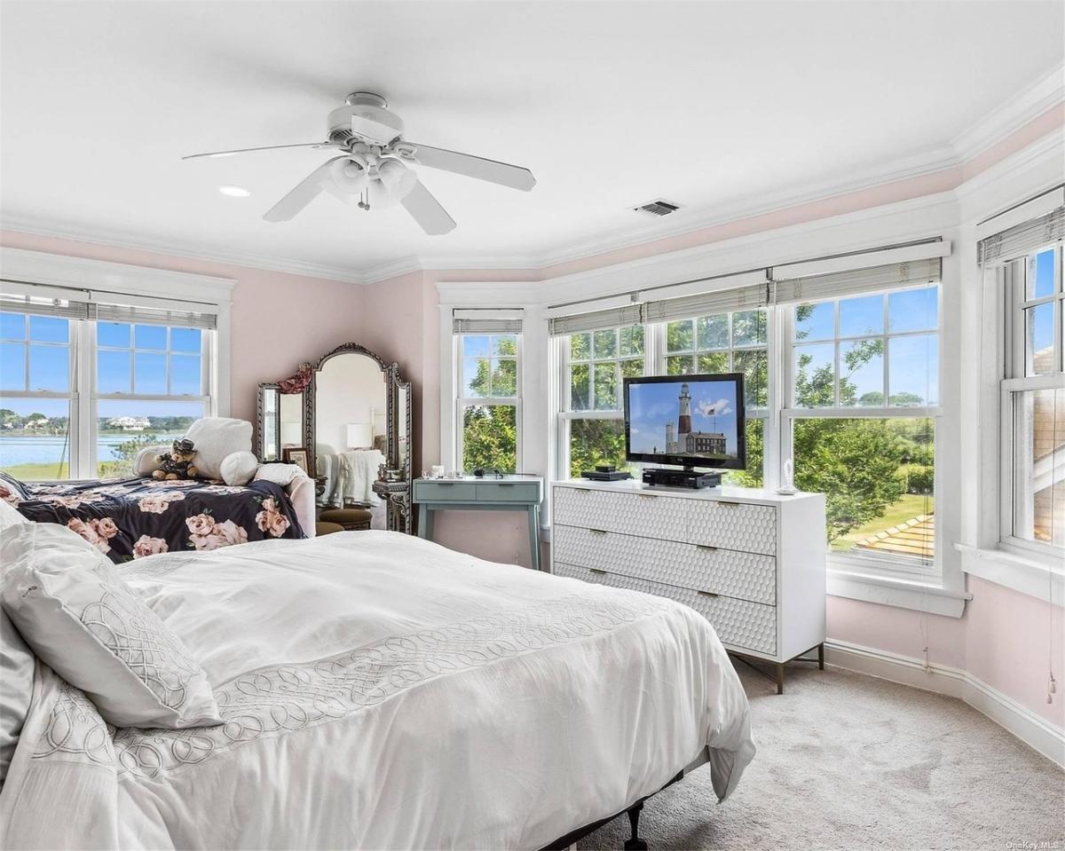 Bedroom with carpet flooring and glass windows.