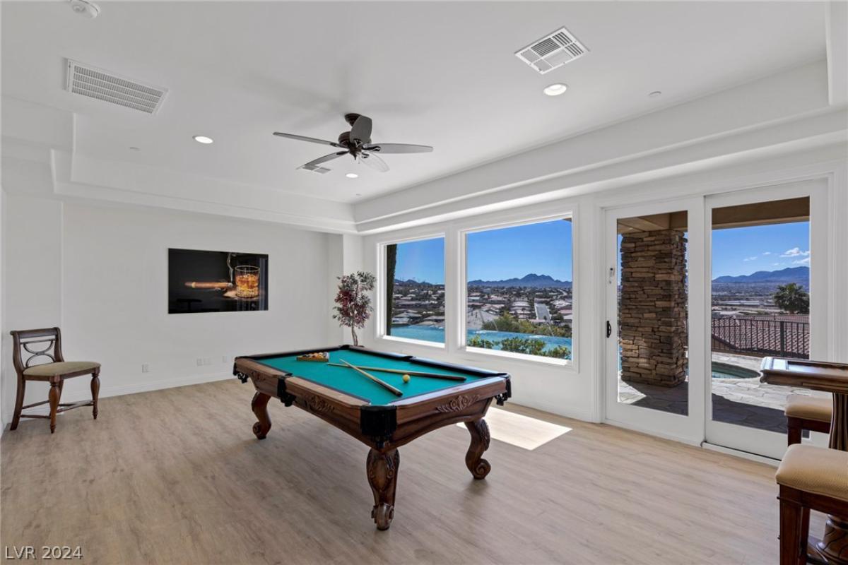 Billiards room with hardwood floors.