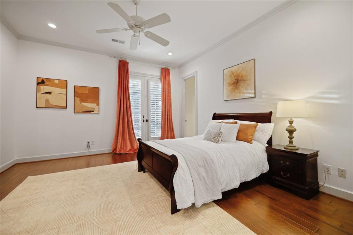 Bedroom with a large bed and hardwood floors.
