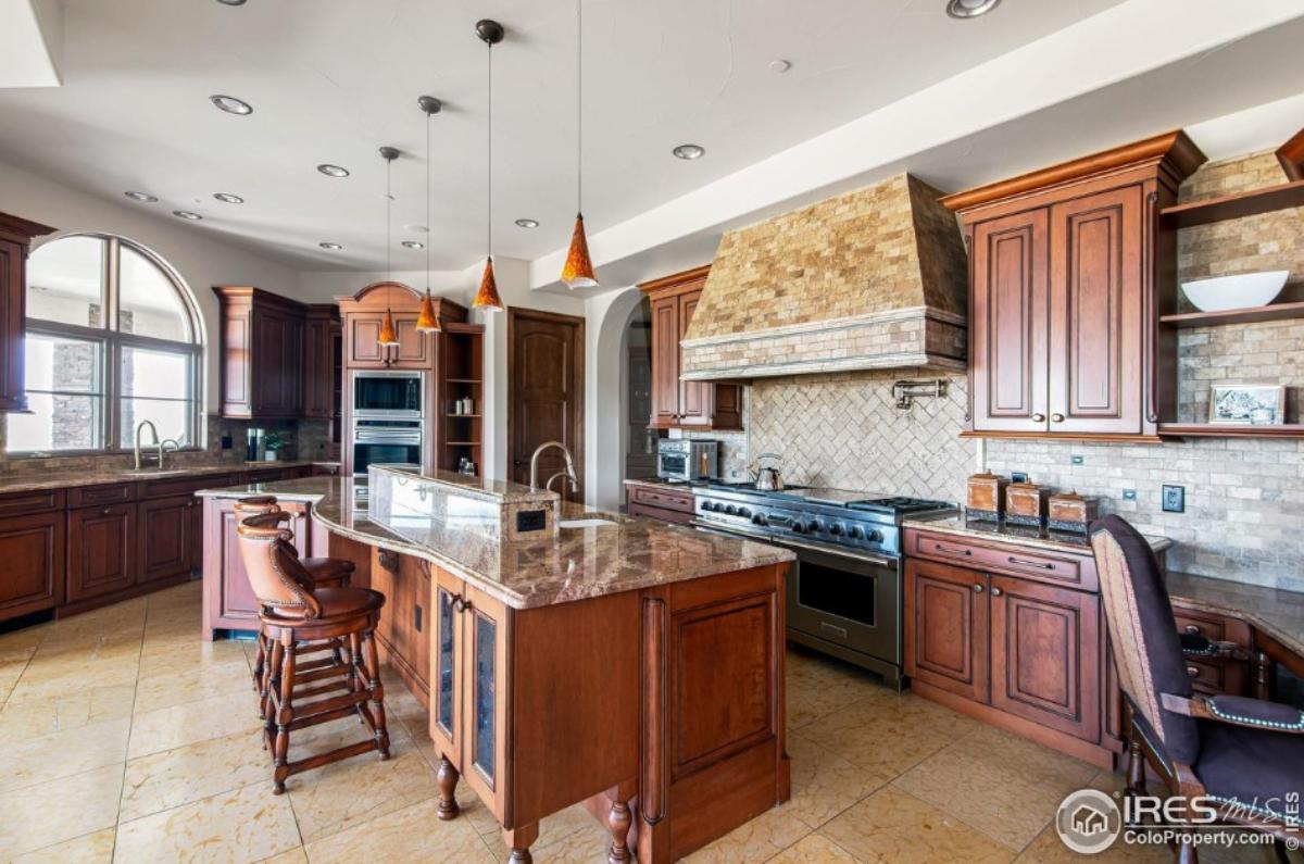 Kitchen with a large island, stainless-steel appliances and custom cabinetry.