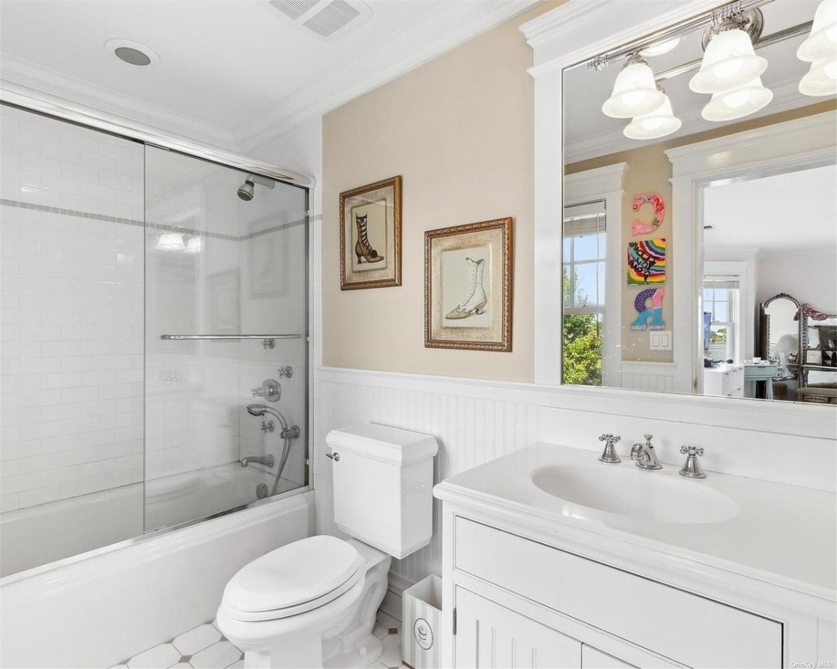 Bathroom with a sink, toilet and a walk-in shower.