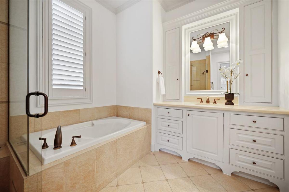 Bathroom with a sink, soaking tub and a walk-in shower.