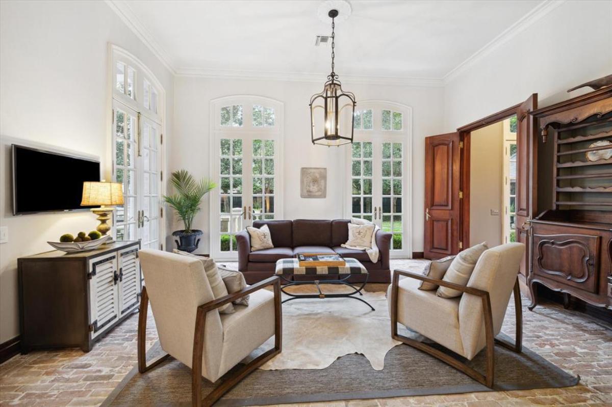 Living room with sofas, chairs and large glass doors.