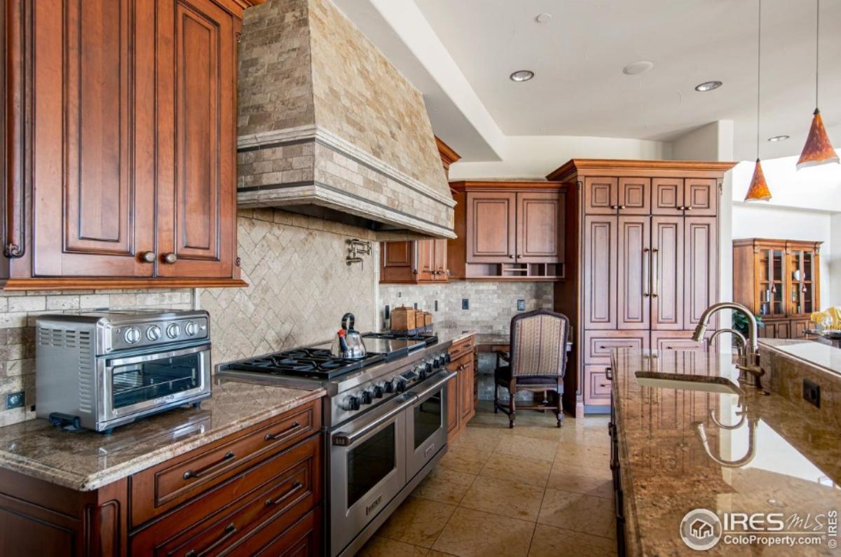 Kitchen with a large island, stainless-steel appliances and custom cabinetry.