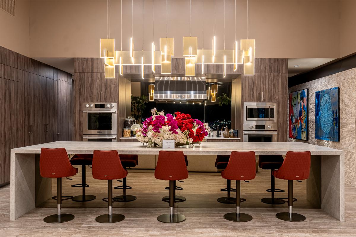 Kitchen with a large island, stainless-steel appliances and a chandelier.