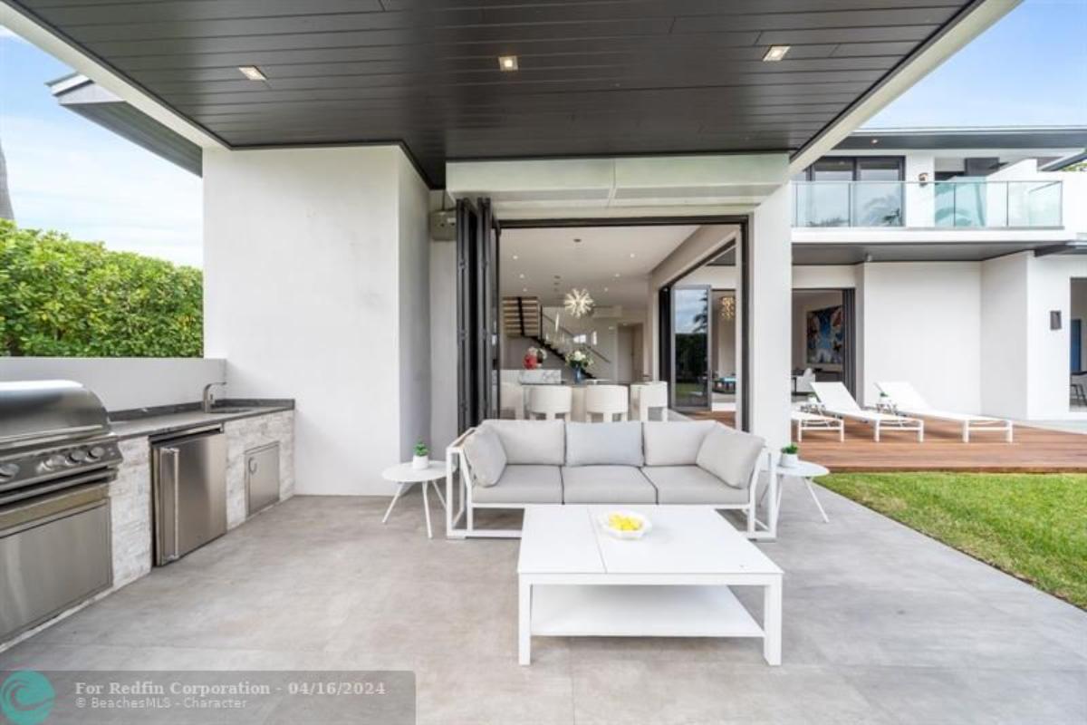 Grill area with a table and couch.