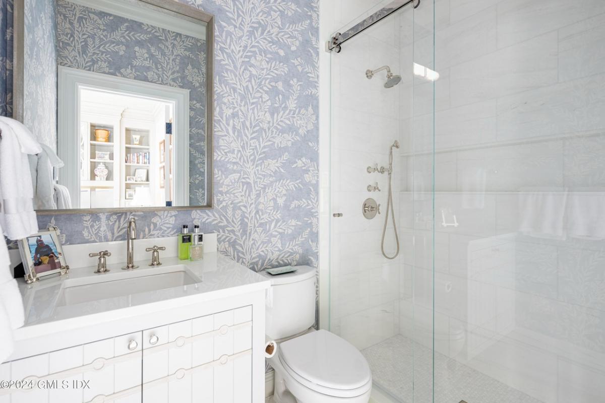 Bathroom with a sink, toilet and a walk-in shower.