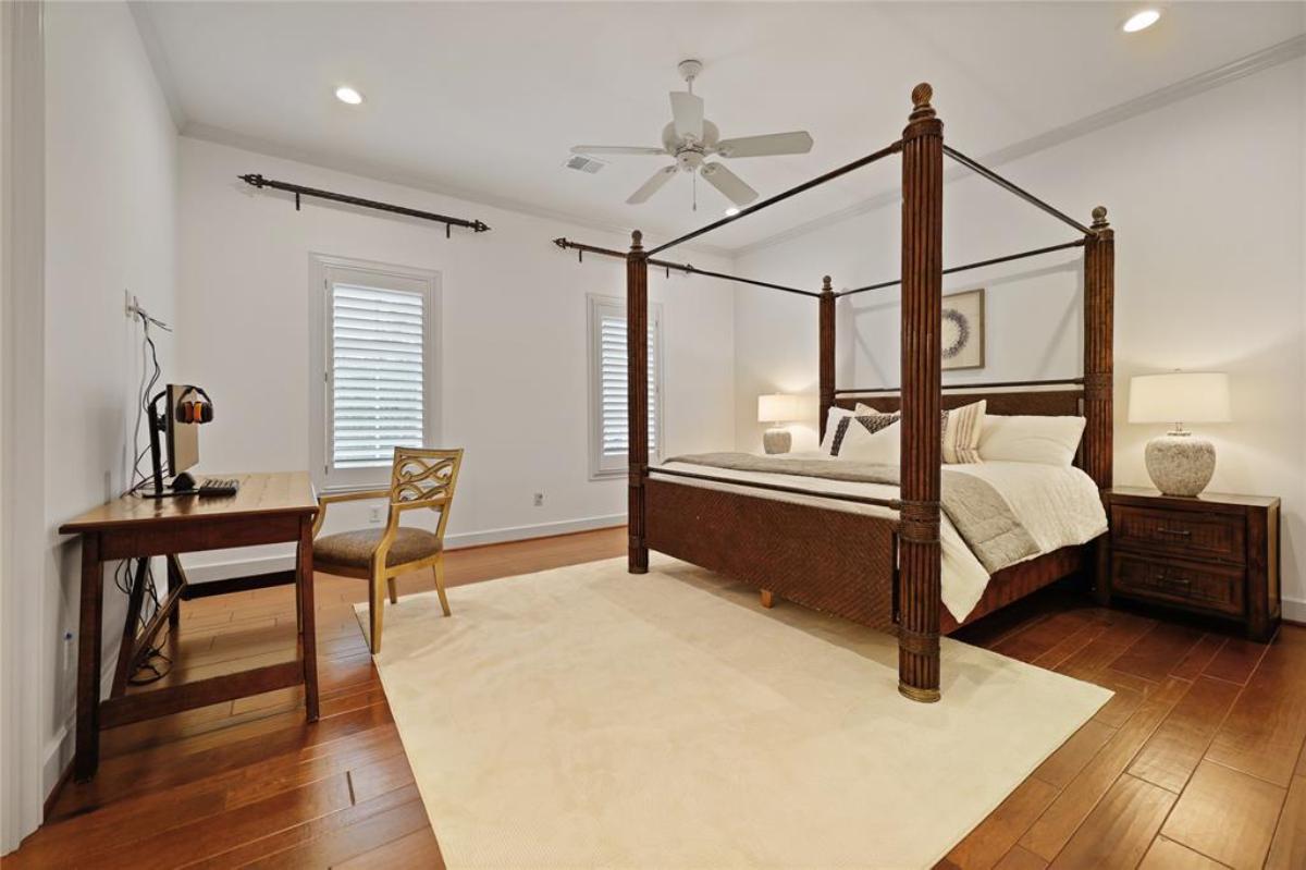 Bedroom with a large bed and hardwood floors.