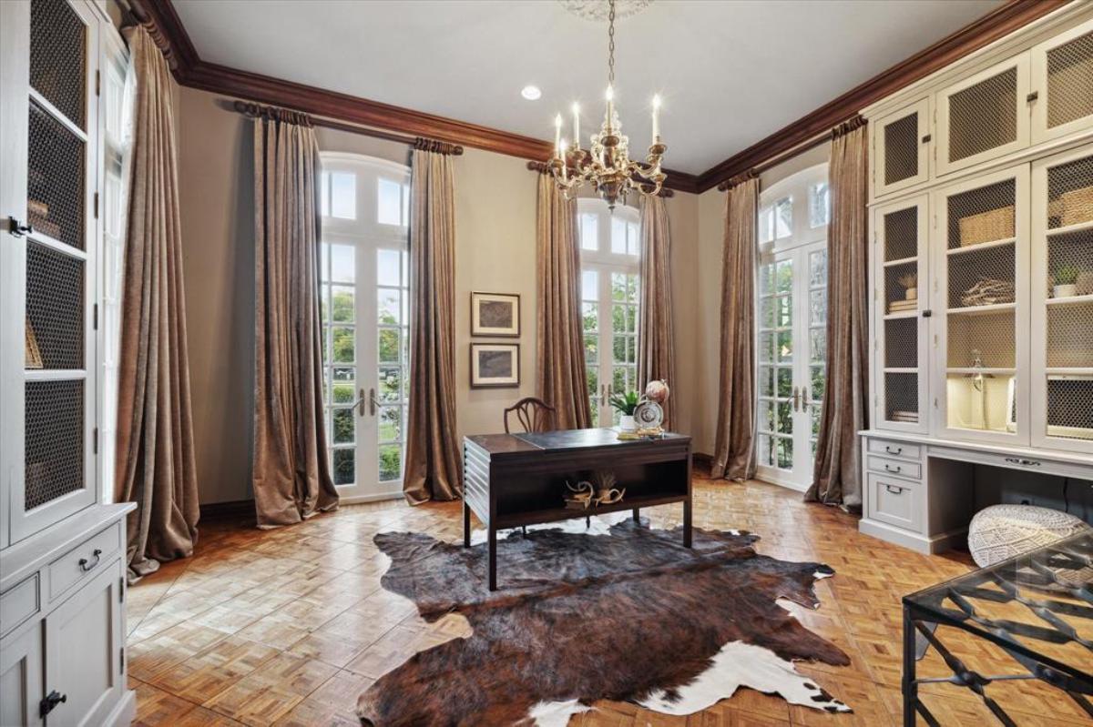 Home office with a chandelier and French doors.