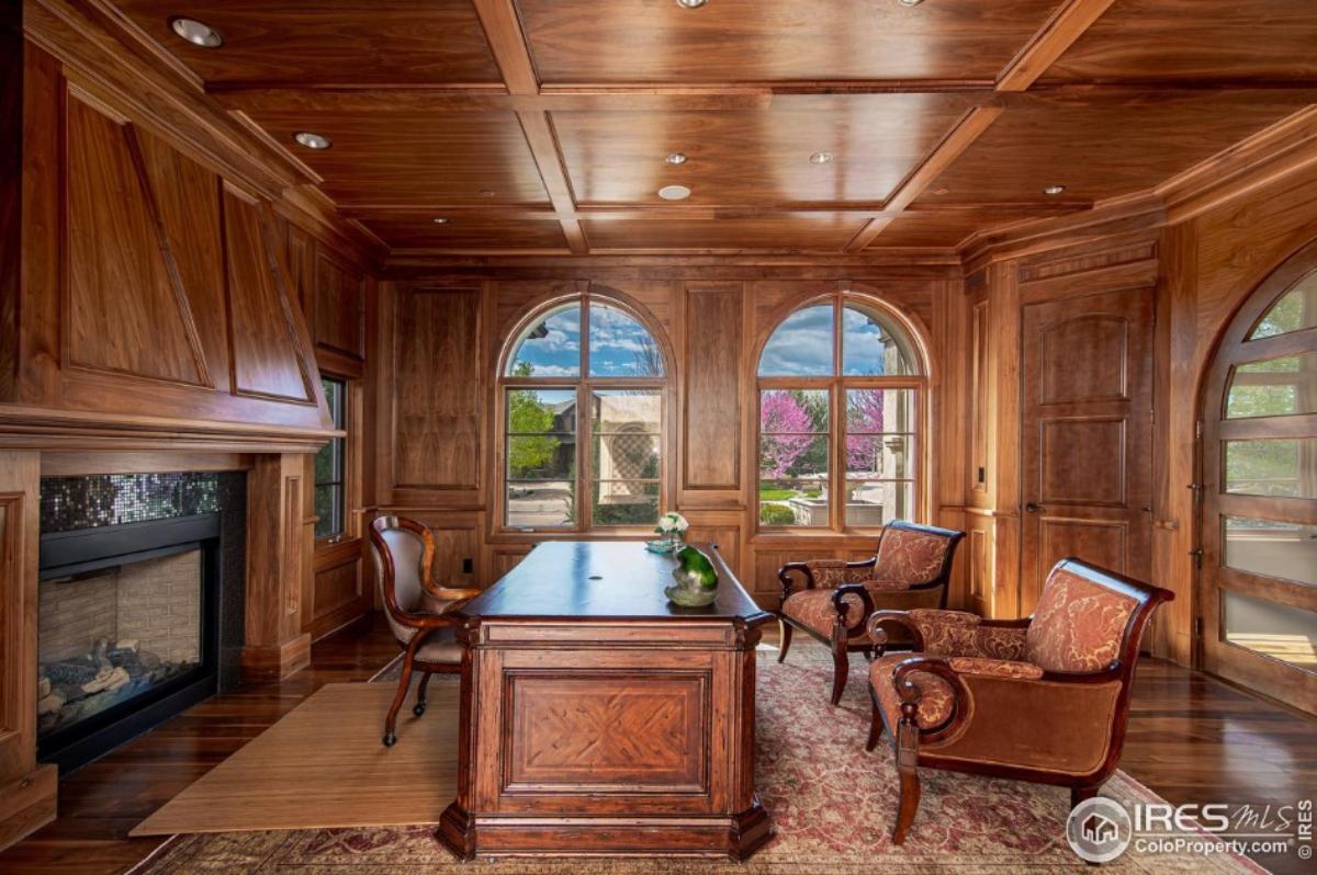Home office with a fireplace.