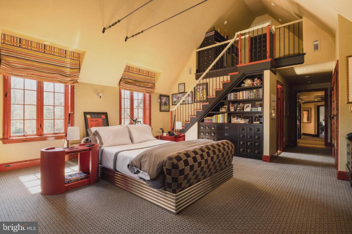 Bedroom with carpet flooring and glass windows.
