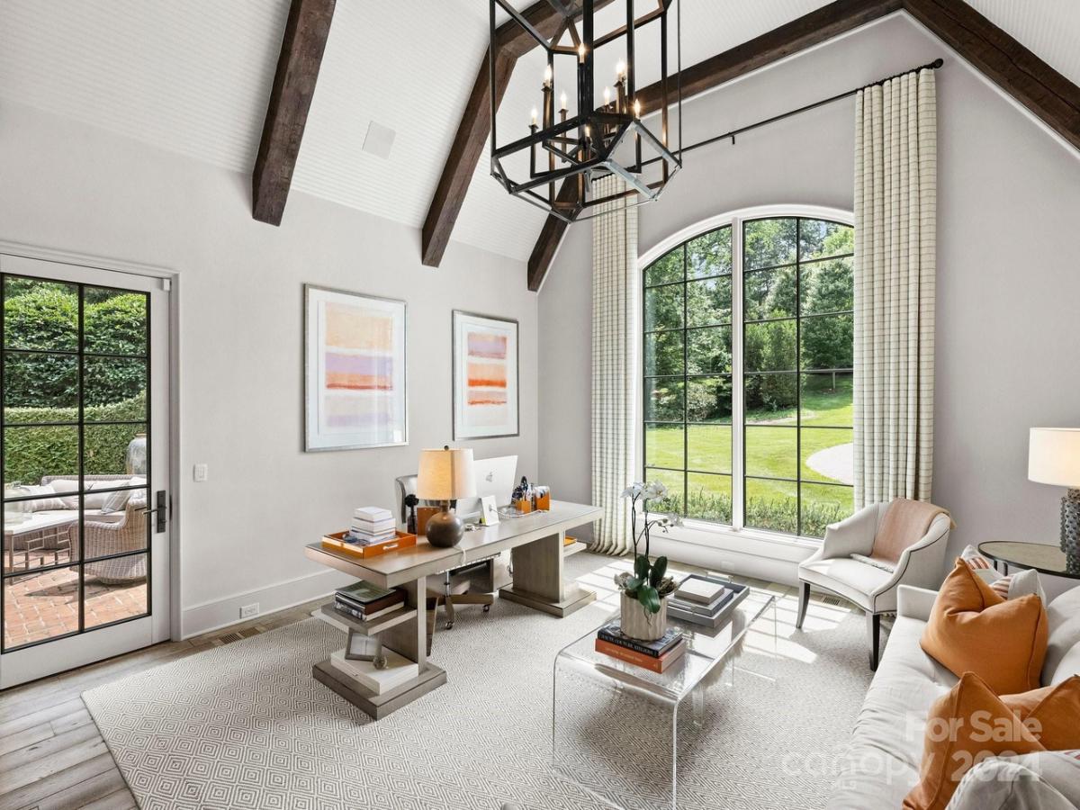 Home office with glass door and glass windows.