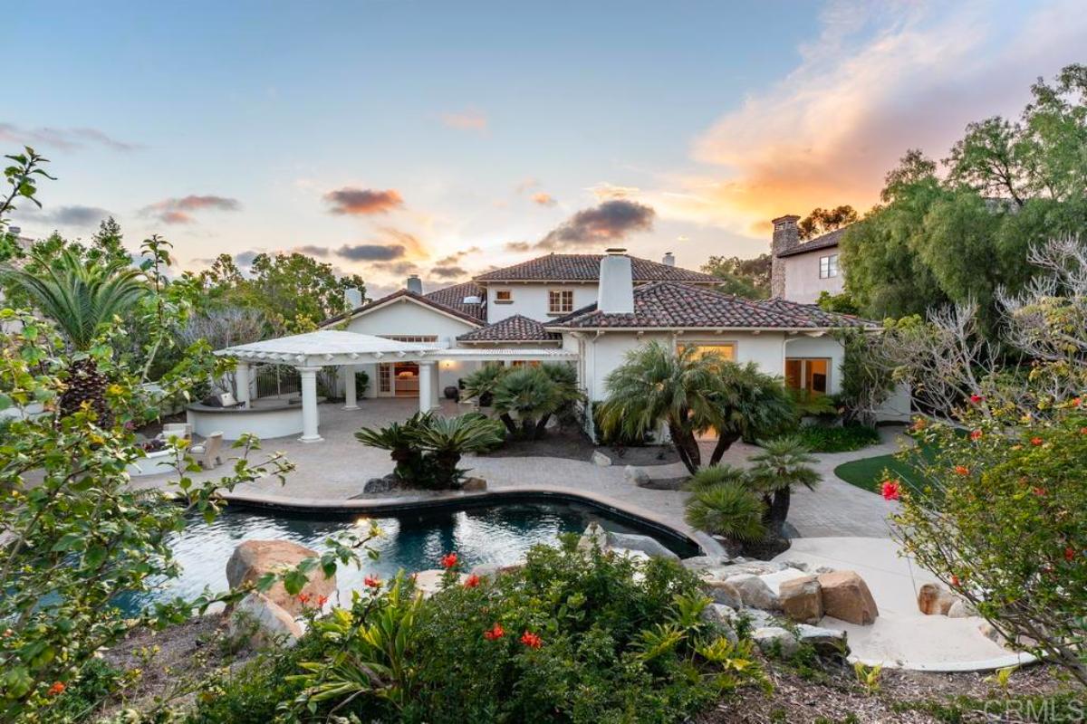 Rear view of the mansion with a pool.