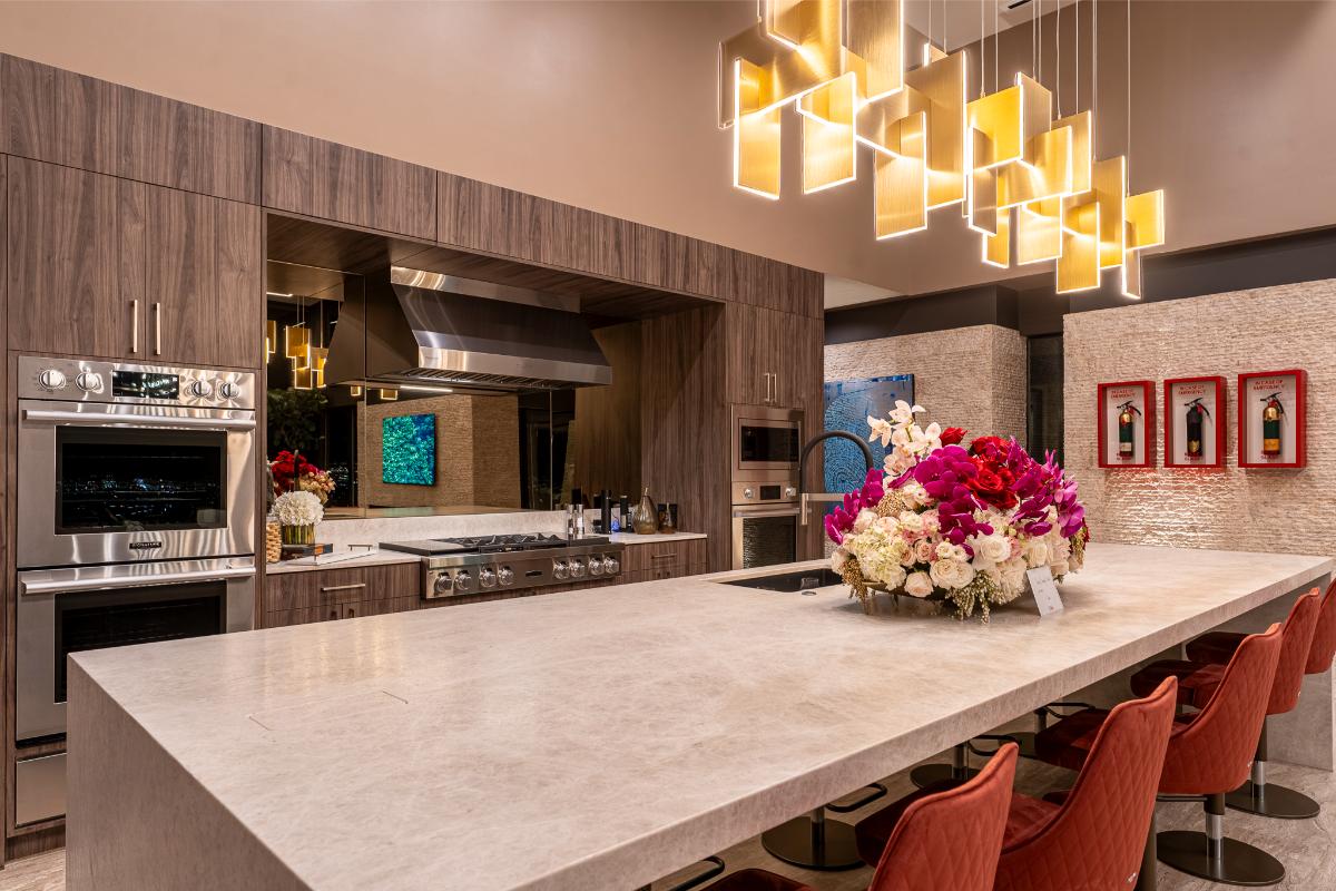 Kitchen with a large island, stainless-steel appliances and a chandelier.