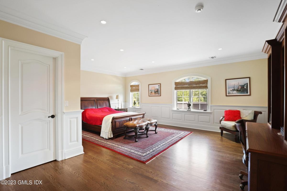 Bedroom with hardwood floors and glass windows.