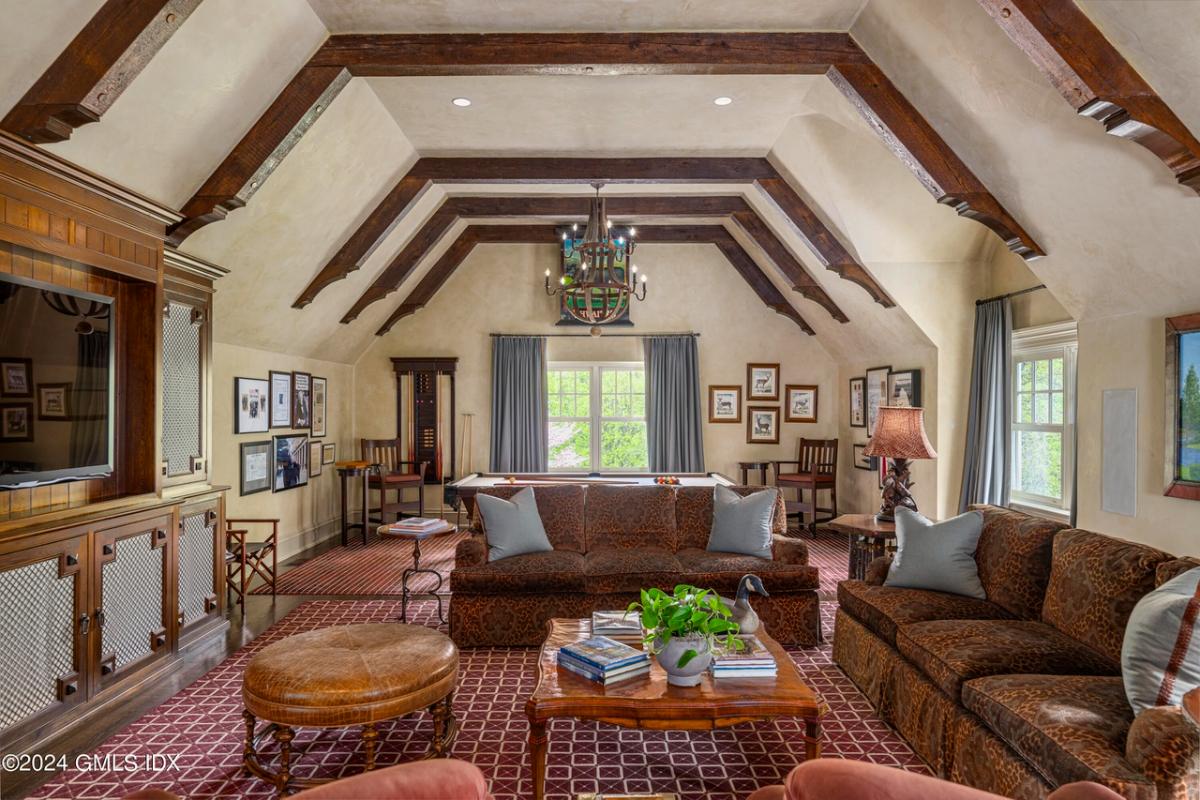 Recreational room with a TV and billiards table.