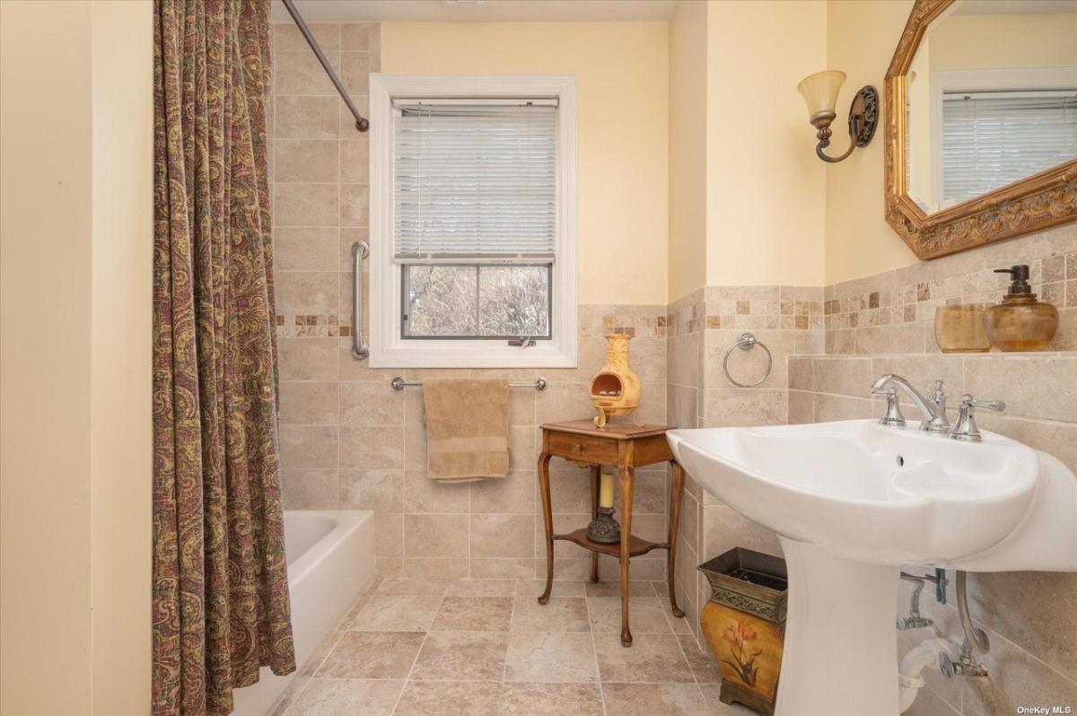 Bathroom with a sink and a shower.