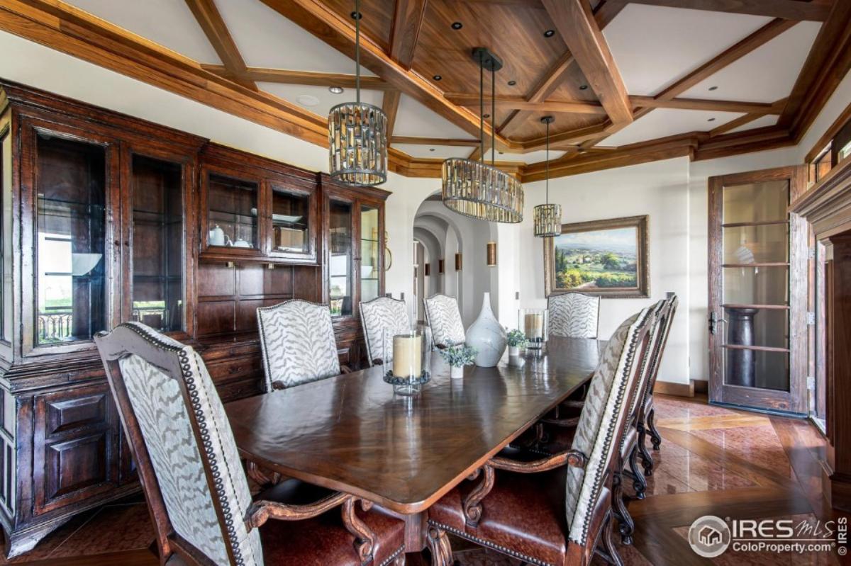 Formal dining room with a large wood table and chairs.