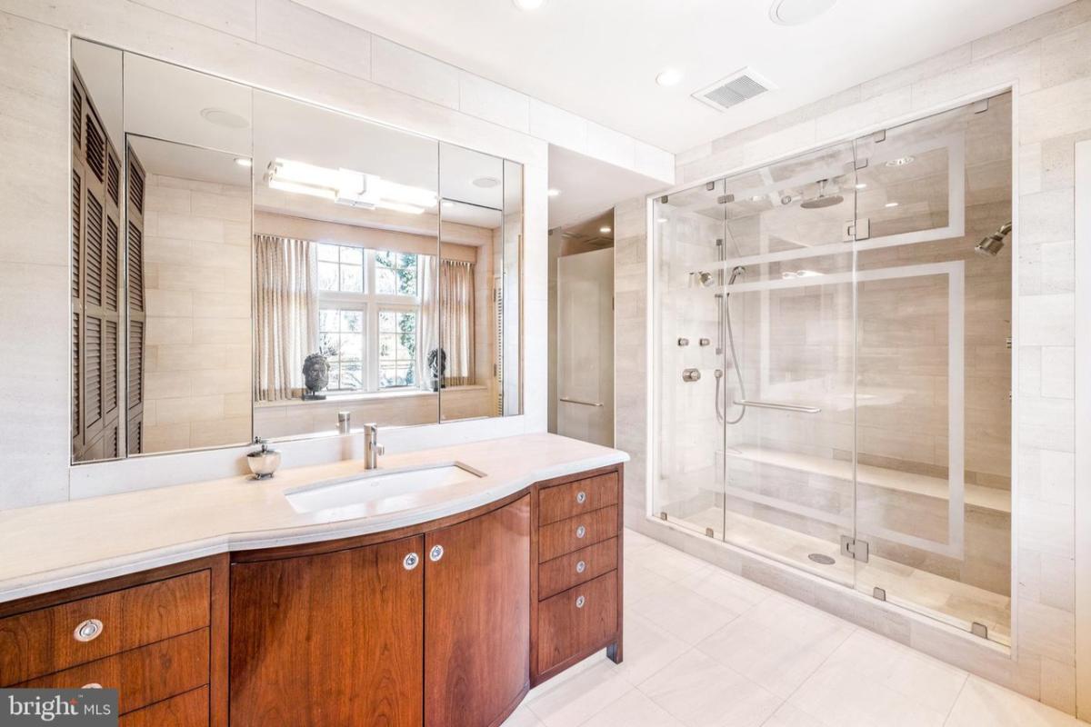 Bathroom with sink and a walk-in shower.