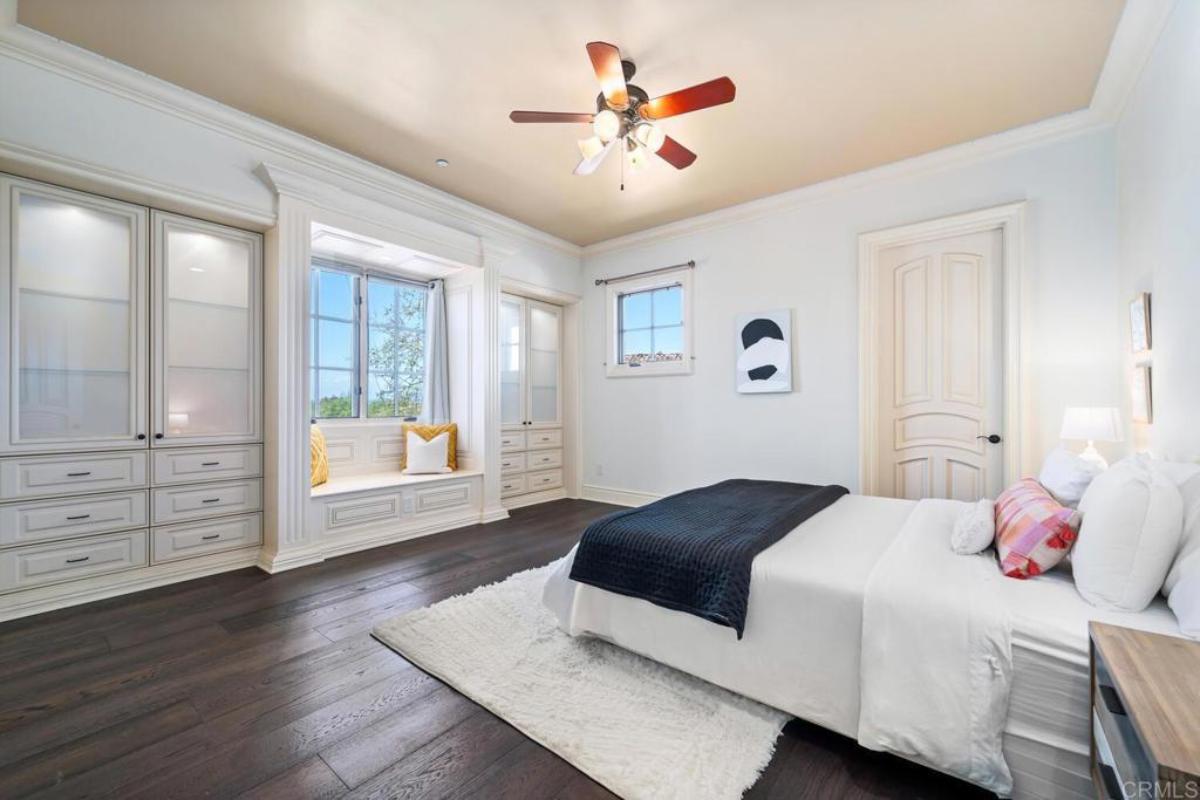 Bedroom with hardwood floors and glass windows.