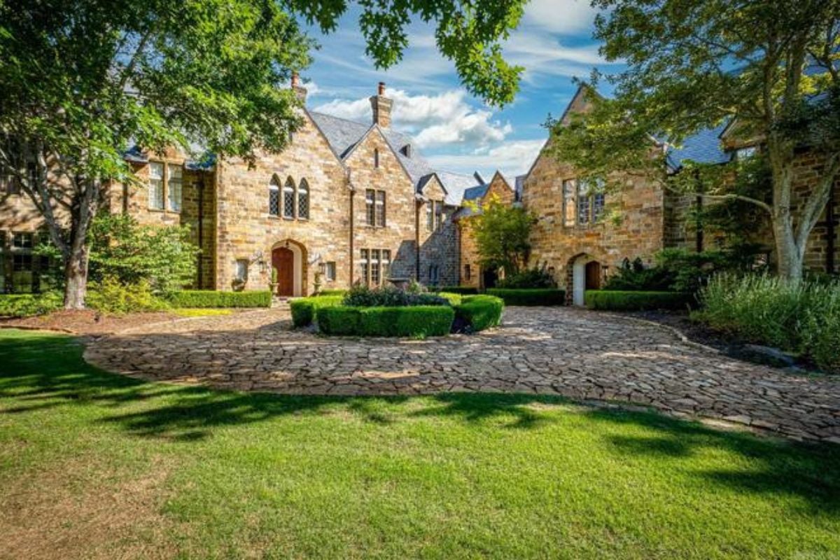 A brick courtyard with plants in the middle.