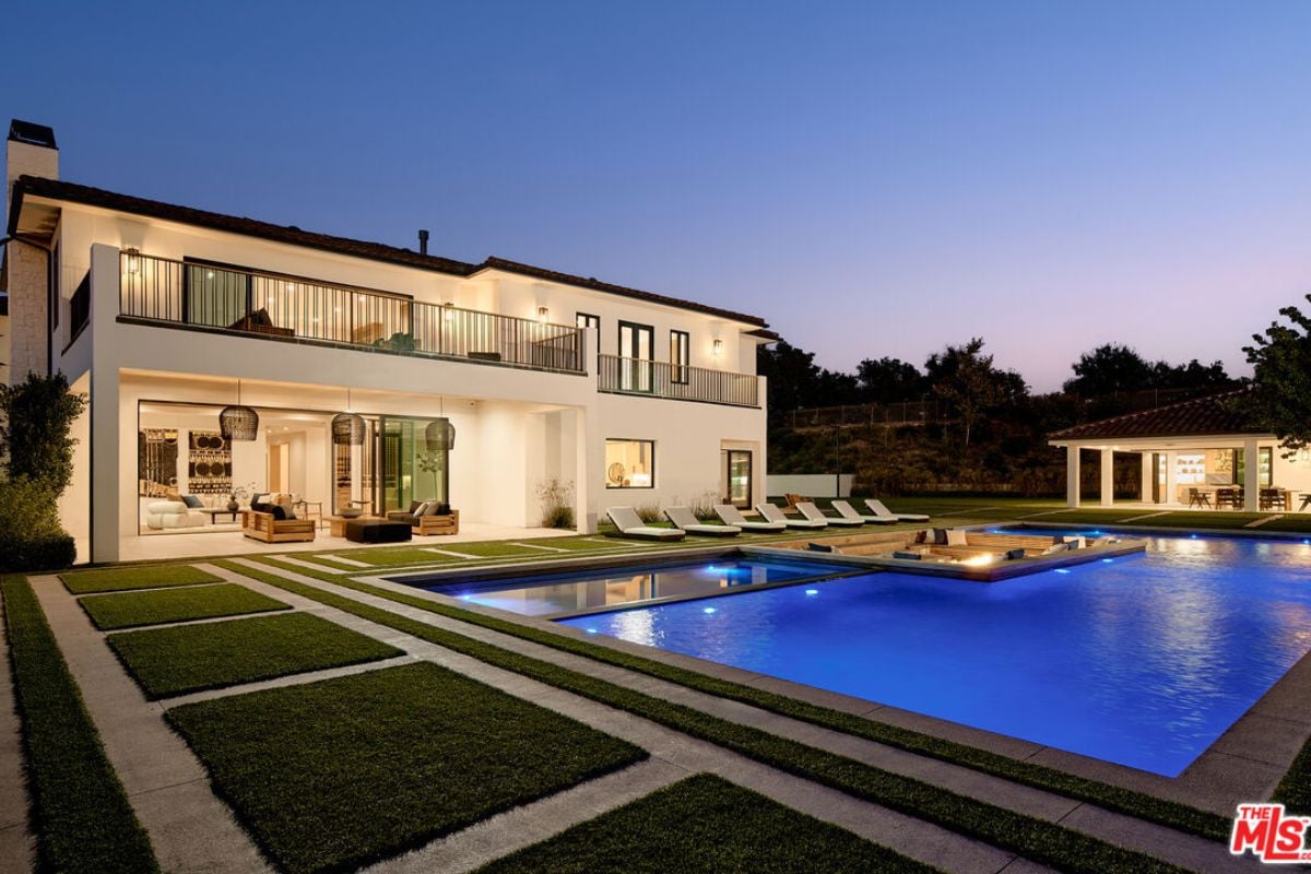 A swimming pool with a conversation pit and fire pit.