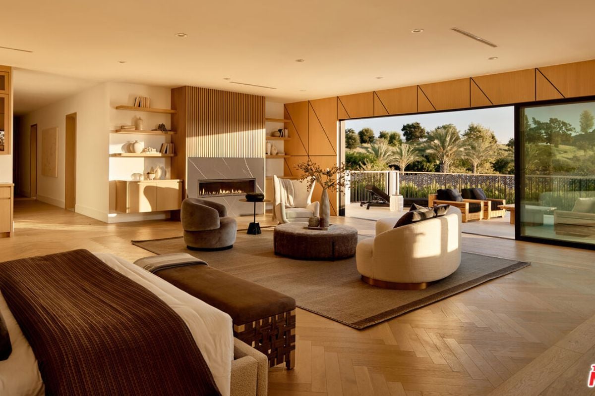 A living room featuring a fireplace, rug, shelves, cabinets, a couch, and a coffee table.