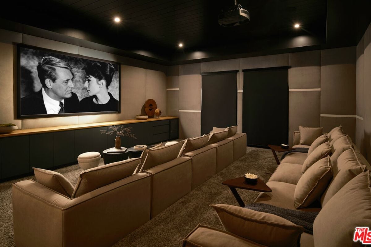 A home theater with a large screen and chairs.