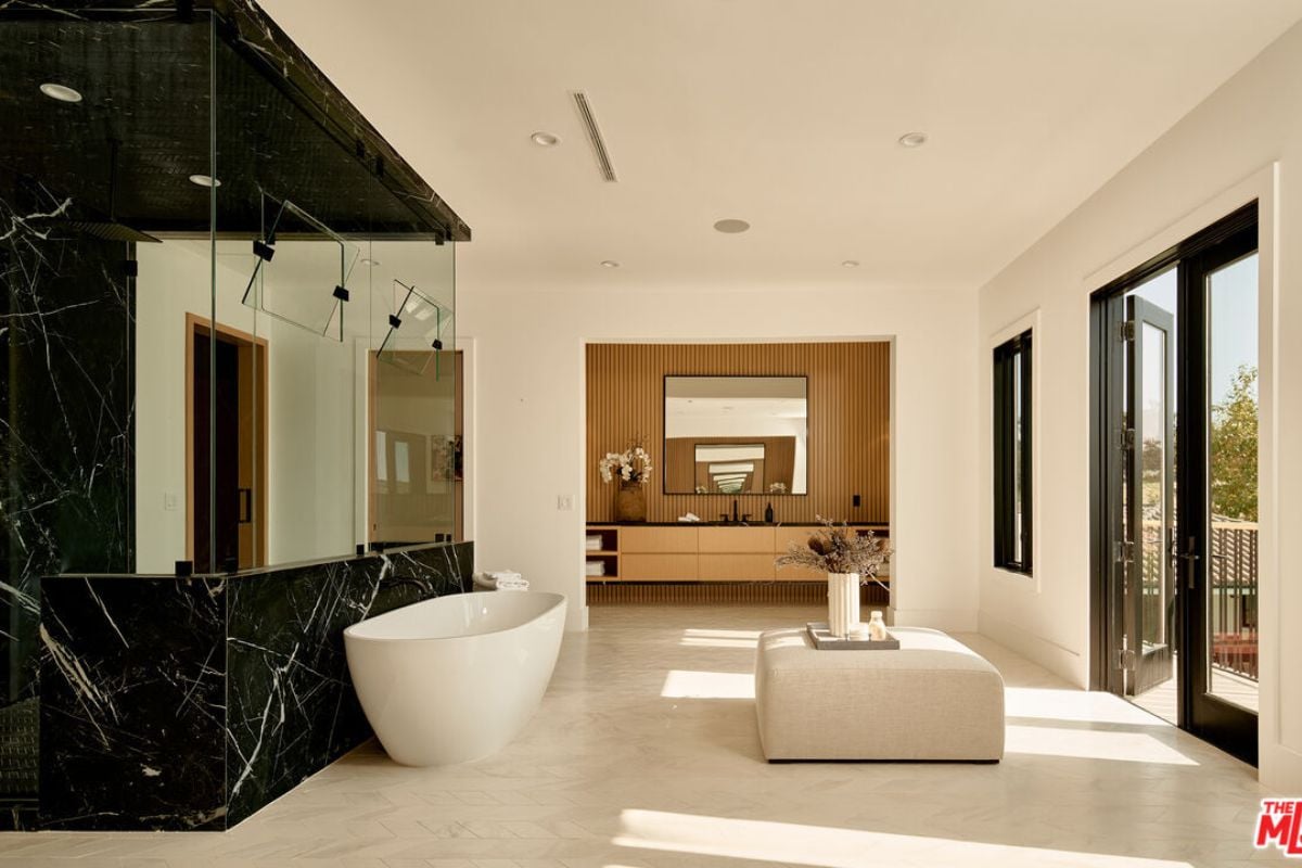 A bathroom with a tiled floor, shower room, and bathtub.