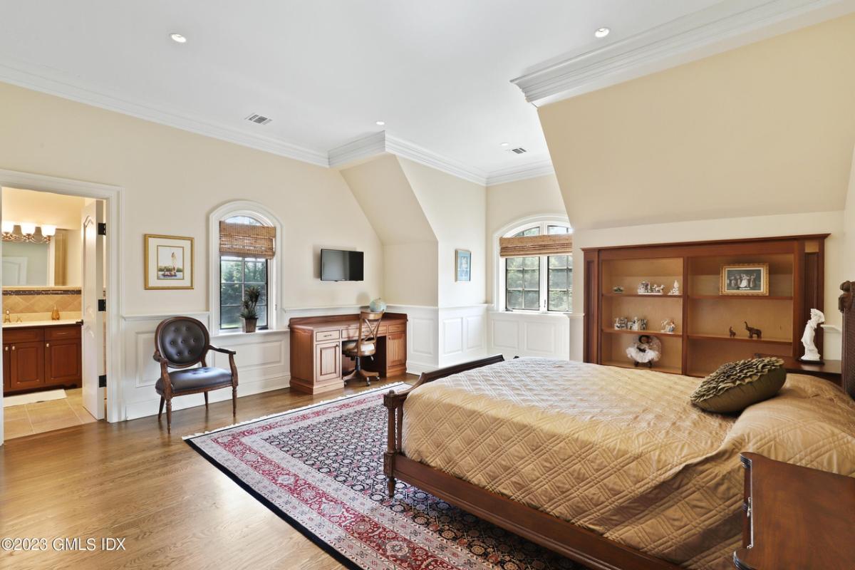 Bedroom with hardwood floors and own bathroom.