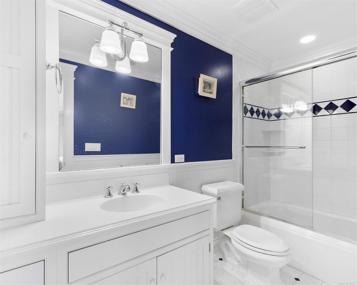 Bathroom with a sink, toilet and a walk-in shower.